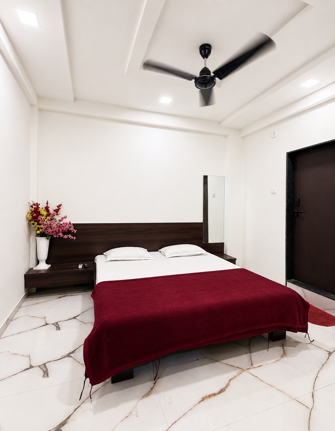 Clean guest room with double bed at Hotel Dnyaneshwari Inn