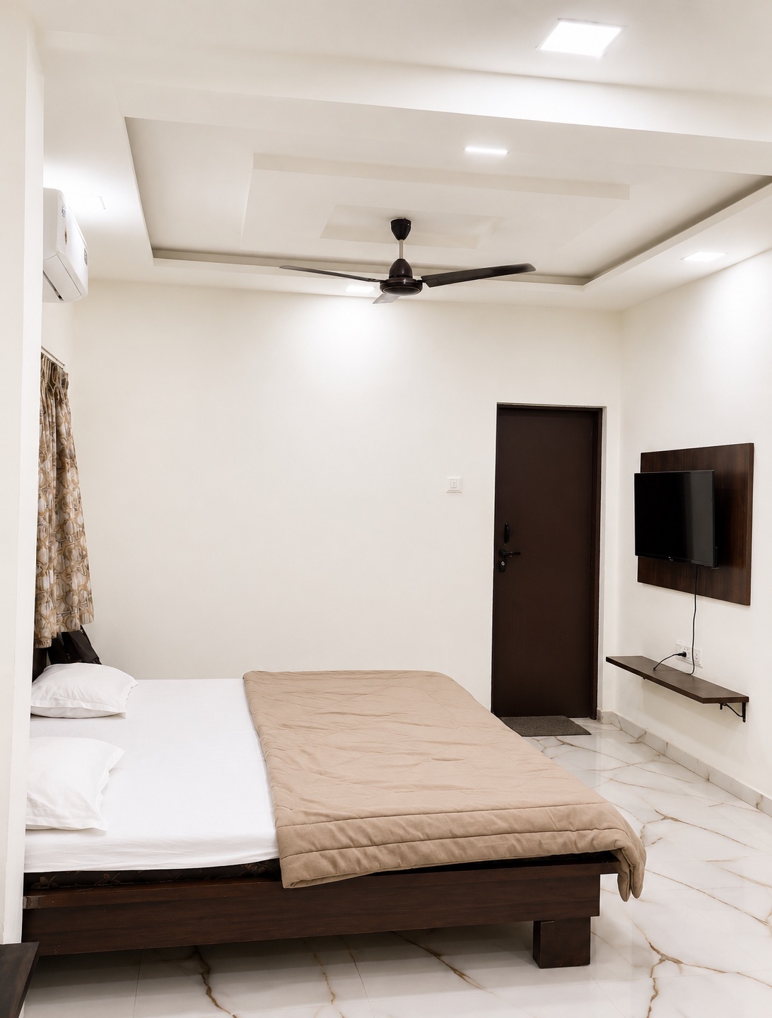 Guest room with TV at Hotel Dnyaneshwari Inn